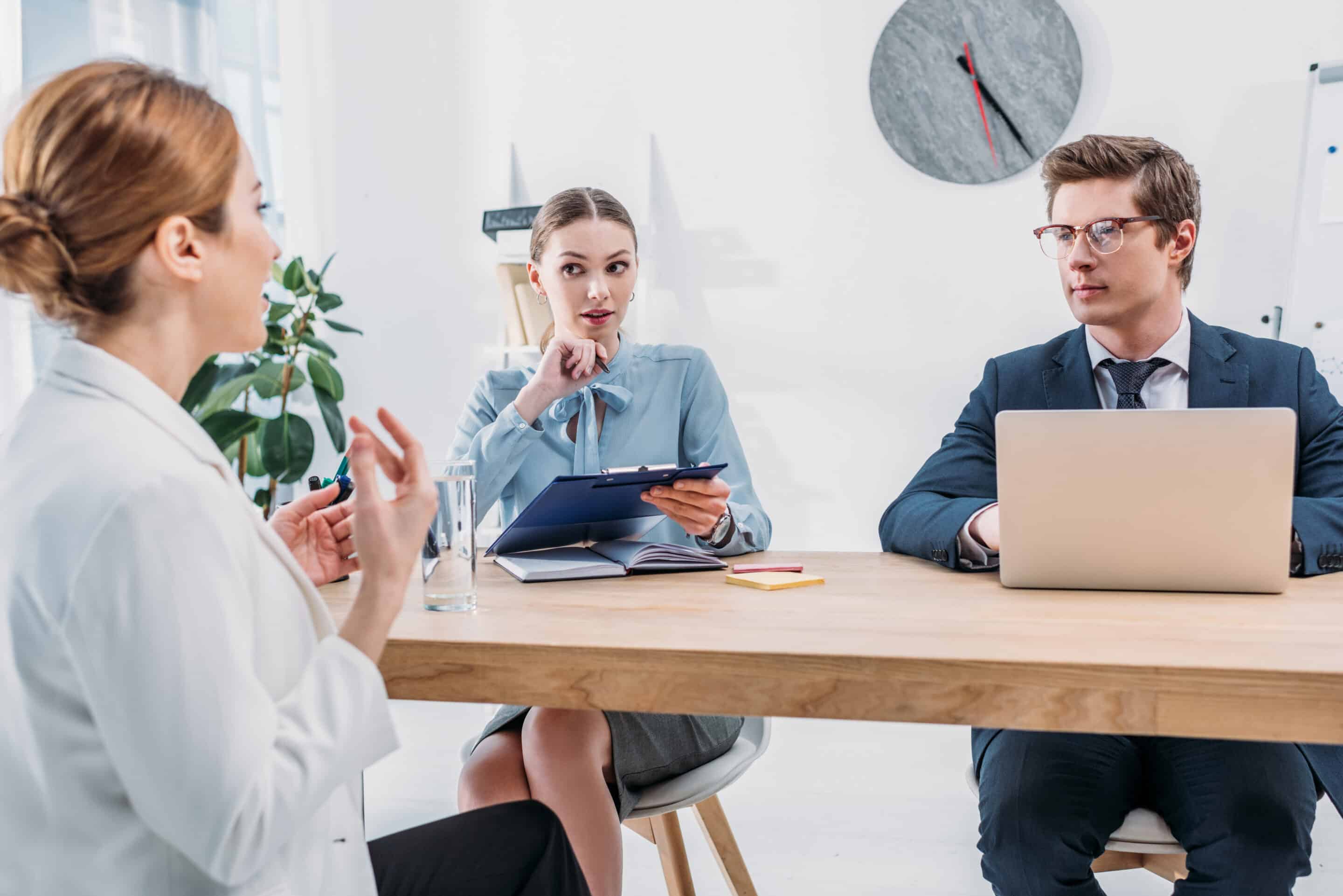 recruiters looking at employee talking on job interview